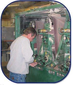 A vintage photo of Chris Peterson working on machinery